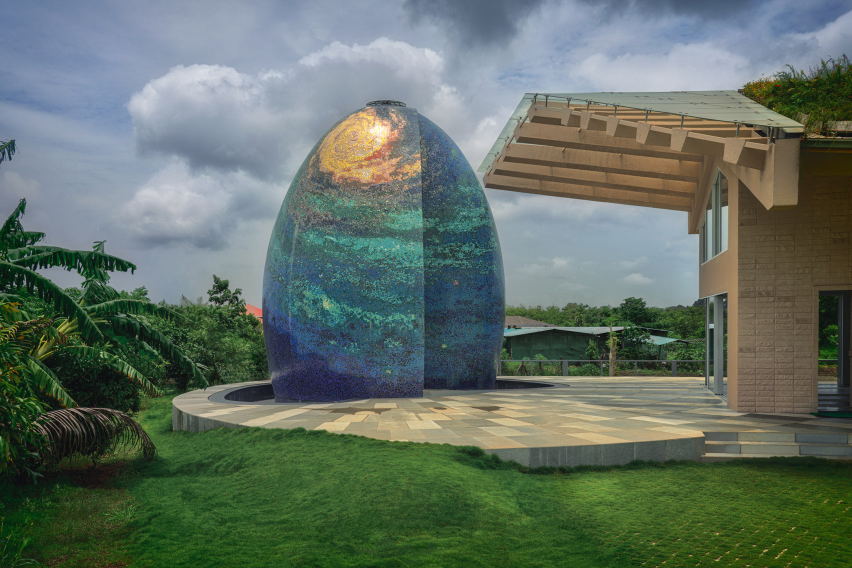 Shiny blue egg-shape temple in a residential garden